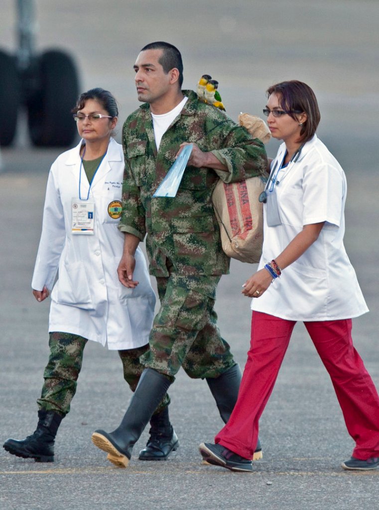 Colombian Army sergeant Robinson Salcedo Guarin walks with two birds perched on his shoulder after being released by the Revolutionary Armed Forces of Colombia in Villavicencio, Colombia, on Monday.