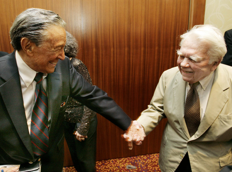Mike Wallace, left, greets colleague Andy Rooney during a reception at the 30th annual Boston/New England Emmy Awards in Boston in 2007.