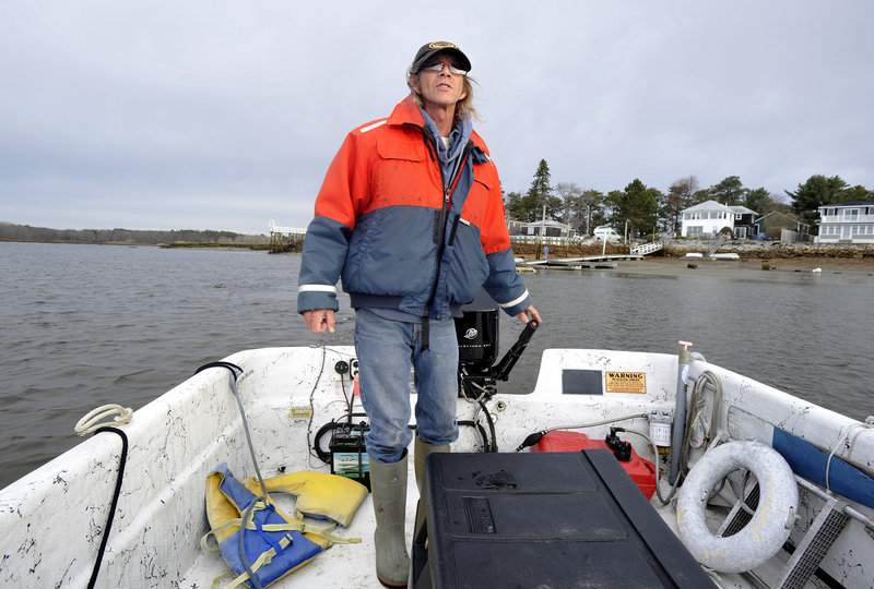 John Ewing/Staff Photographer “Captain Carl” Lagerstrom operates the 24-foot maritime skiff that shuttles passengers back and forth across the Saco River for a three-week pilot river ferry service.