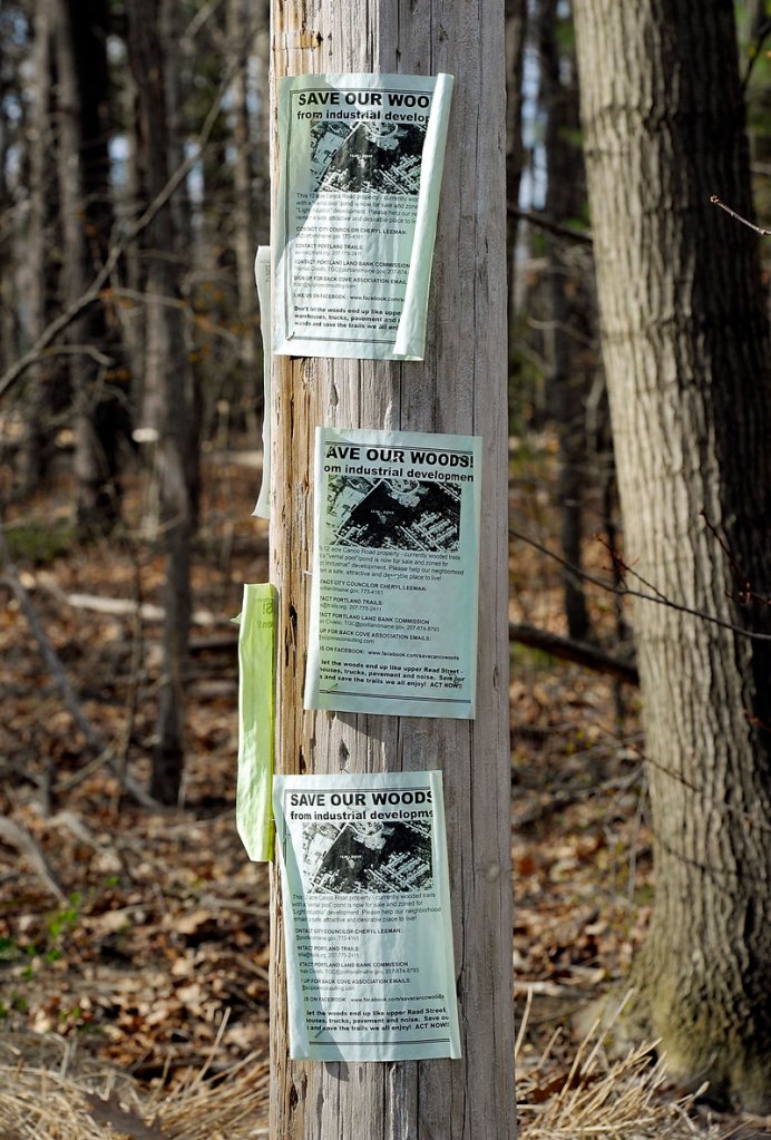 Neighbors of “Canco Woods” have posted signs to draw attention to the parcel’s impending sale and to rally people to help save the neighborhood oasis.
