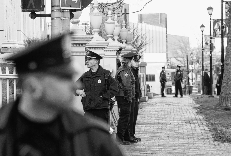 Portland police officers secure Spring Street as President Obama visits the Portland Museum of Art March 30.