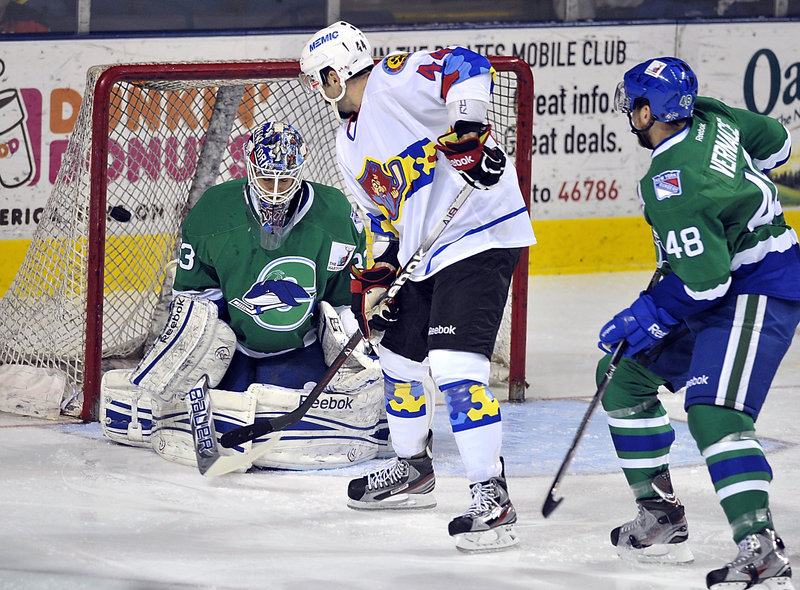 Ashton Rome of the Pirates tips in the first goal of the game against Whale goalie Cam Talbot Wednesday night in Portland. The Pirates won, 2-1.