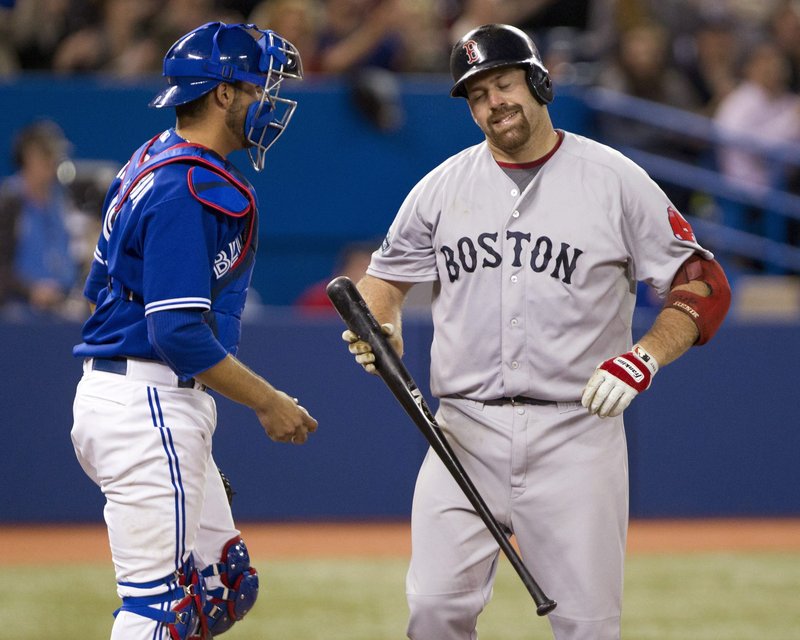 Kevin Youkilis of the Red Sox grimaces Wednesday after striking out in the ninth inning with the tying runs in scoring position in a 3-1 loss at Toronto. The catcher is J.P. Arencibia.
