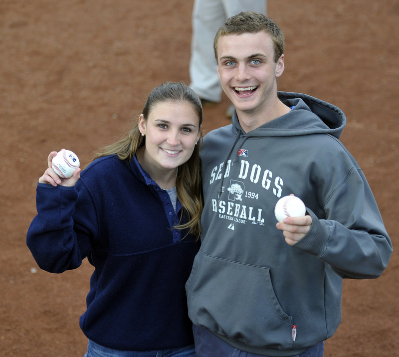 Annie McNamara, left, and Chris Burke prepare to throw out the first pitch. Their grandfather, Dan Burke, who died in October, founded the Sea Dogs for the 1994 season.