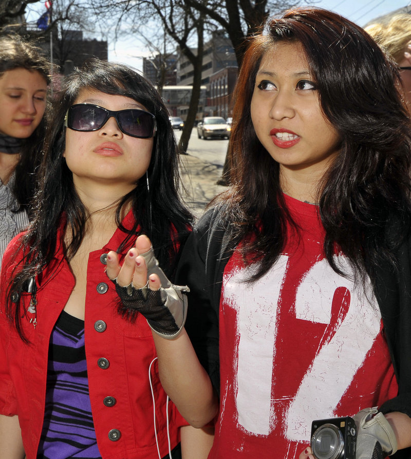 Sengmolicka Vuthy, 15, a student at South Portland High School, right, and Thinavysen Thach, 17, a student at Portland High, talk about the new regulations for teenage drivers Friday.