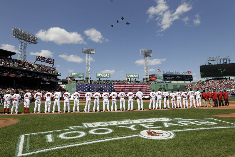 THE GOOD NEWS: The Boston Red Sox returned to Fenway Park in dramatic fashion Friday, winning their home opener against the Tampa Bay Rays 12-2. Above, players line up for the national anthem as fighter jets from the Vermont National Guard fly over Fenway before the afternoon game.