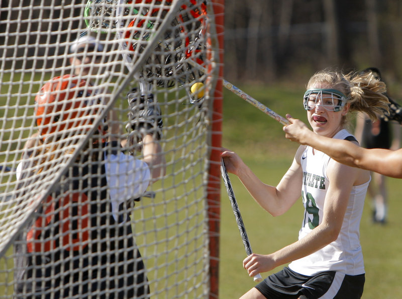 Martha Veroneau of Waynflete prepares to shoot Friday against North Yarmouth Academy goalie Mallory Ianno. Veroneau scored four goals, helping Waynflete to a 15-5 victory.