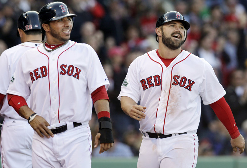 Mike Aviles, left, and Kelly Shoppach are all smiles after scoring on a Ryan Sweeney single – part of an eight-run eighth inning for the Red Sox.