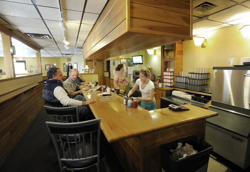 Danielle Thompson, right, waits on customers at Maelily Ryleigh’s during lunch hour.