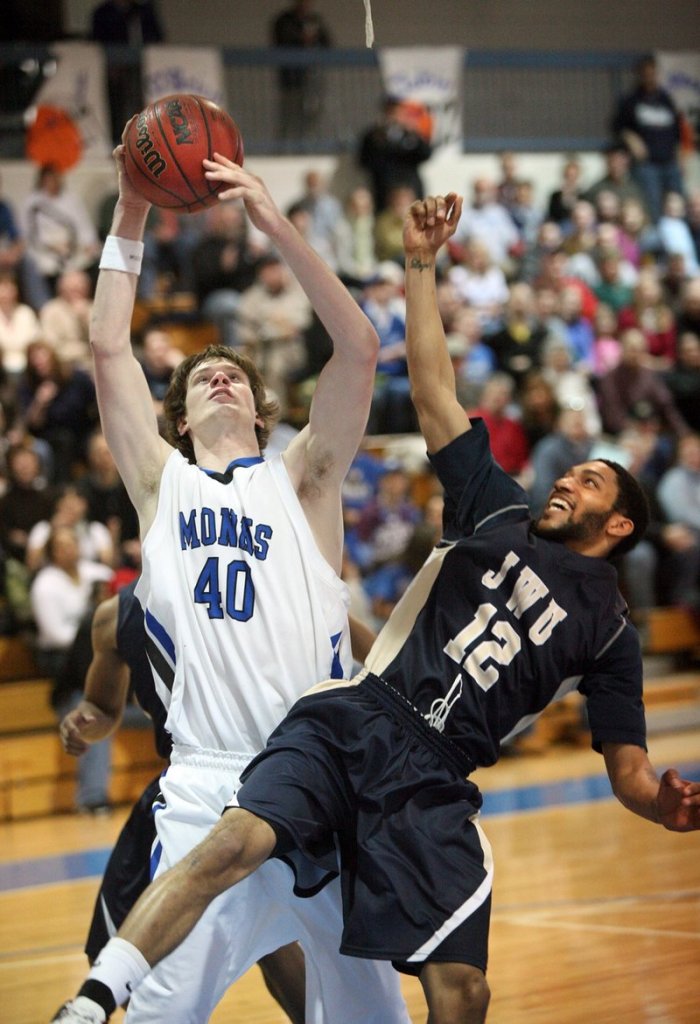 Clark Noonan, left, of Saint Joseph’s College in Standish, pulls down a rebound over Darren Faust of Johnson & Wales University in a conference title game last year. Noonan, who was killed in a car crash early Saturday, was remembered by a former coach as a hardworking player who made himself into a star.