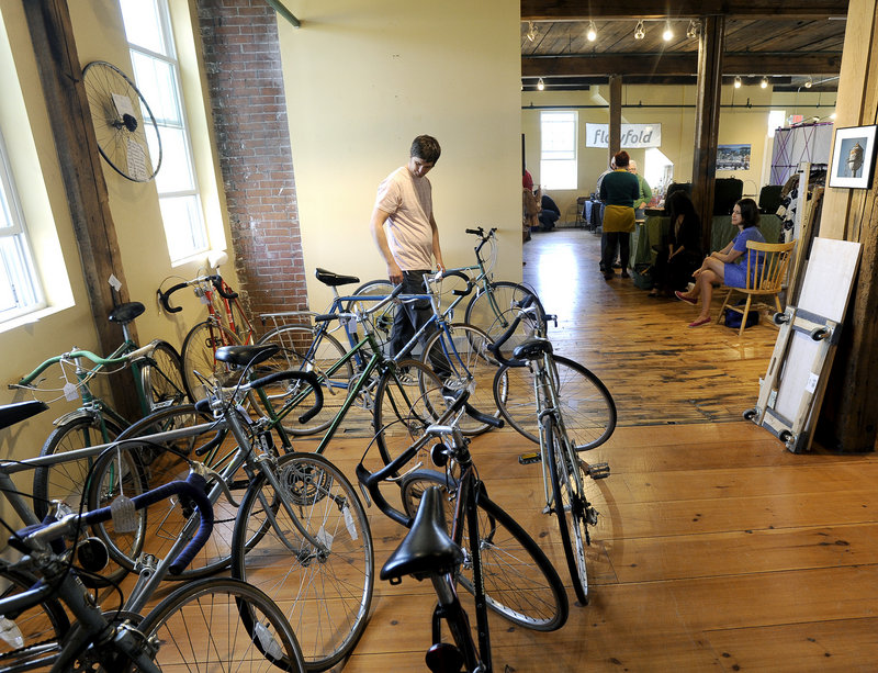 Andrew Erwin of South Portland checks out bikes at the new Flea-for-All market in Portland on Saturday.