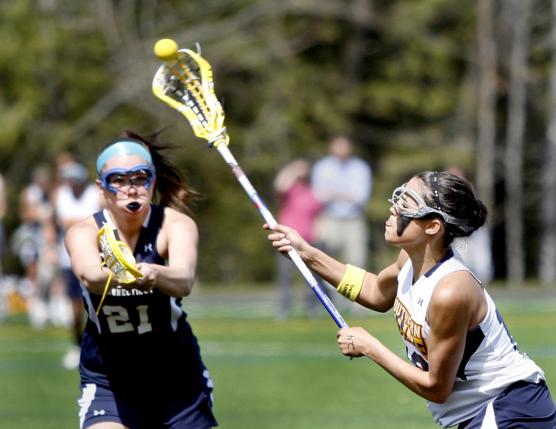 Rosie Fortser of the University of Southern Maine fires a shot as Hyla Costello of Western Connecticut State University tries to defend during Saturday’s women’s lacrosse game at Gorham. USM won, 16-9.