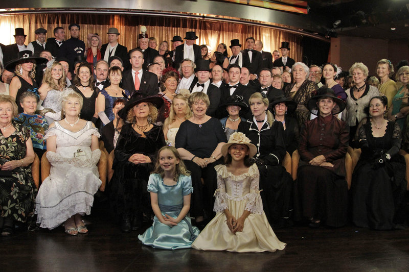 Passengers in costume pose Friday for a picture following a reception on the MS Balmoral Titanic memorial cruise.
