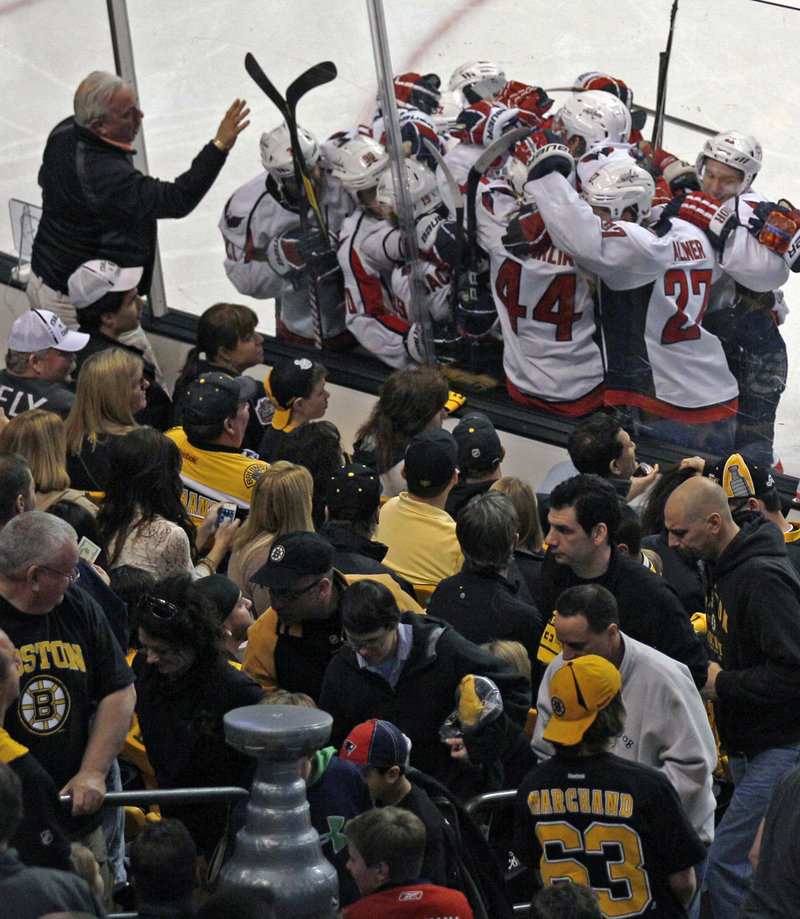 The Caps surround Nicklas Backstrom, who scored in double OT Saturday for a 2-1 win over the Bruins in Game 2 of their playoff series.
