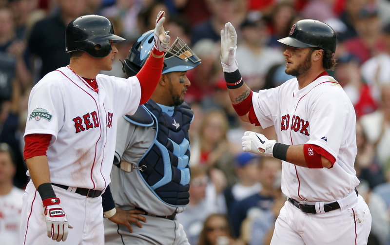 Jarrod Saltalamacchia of the Boston Red Sox, right, celebrates his two-run homer that drove in Ryan Sweeney, left, during the second inning of the 13-5 victory Saturday against the Tampa Bay Rays. The Tampa Bay catcher is Jose Molina.