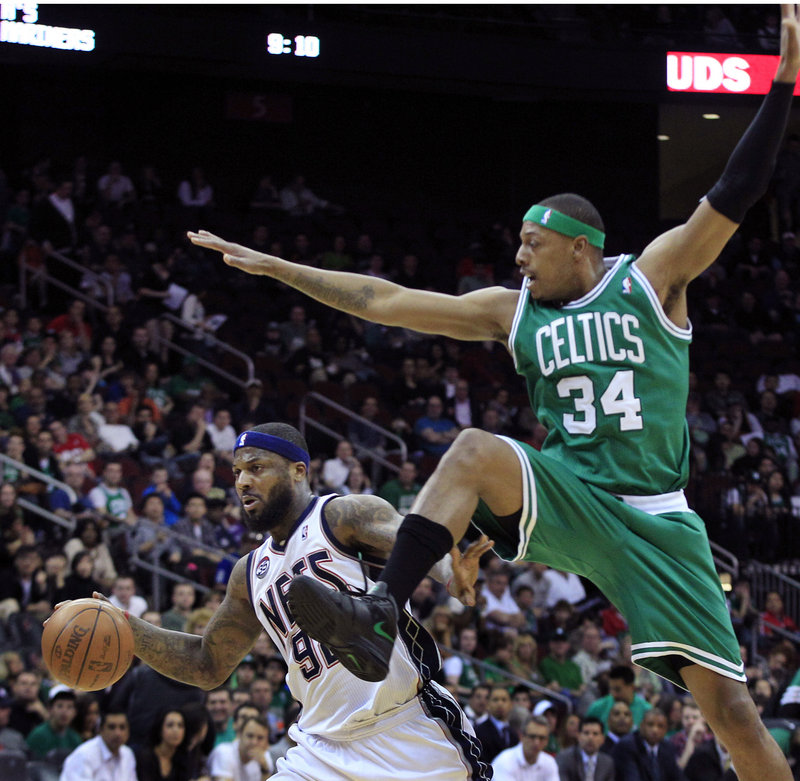 DeShawn Stevenson of the New Jersey Nets heads to the basket past Paul Pierce of the Boston Celtics during the first quarter Saturday night. The Celtics won, 94-82.