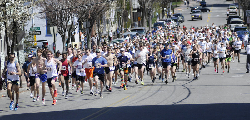 Runners take off at the start of the 83rd annual Patriots Day 5-Miler on Sunday in Portland.