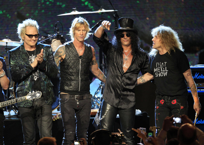 Guns N’ Roses, from left, Matt Sorum, Duff McKagan, Slash and Steven Adler, are shown after their performance following induction into the Rock and Roll Hall of Fame early Sunday in Cleveland.