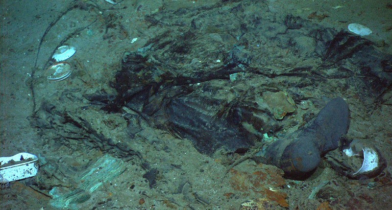 This photo provided by the Institute for Exploration, Center for Archaeological Oceanography/University of Rhode Island/NOAA Office of Ocean Exploration shows the remains of a coat and boots in the mud on the sea bed near Titanic’s stern, which may be evidence of where a victim of the disaster came to rest when the famous passenger ship sank after striking an iceberg 100 years ago.