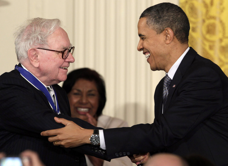 President Obama greets Warren Buffett, after whom the so-called “Buffett rule” is named.