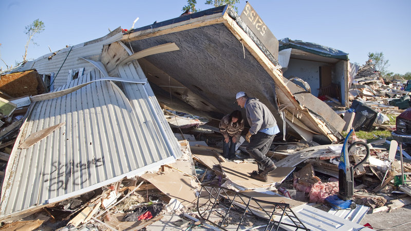 Richard Keith helps sister-in-law Mitzi Keith with salvage and cleanup work Tuesday in Pinaire Mobile Home Park after a tornado swept through the Oaklawn neighborhood in southeast Wichita, Kans., on April 14.