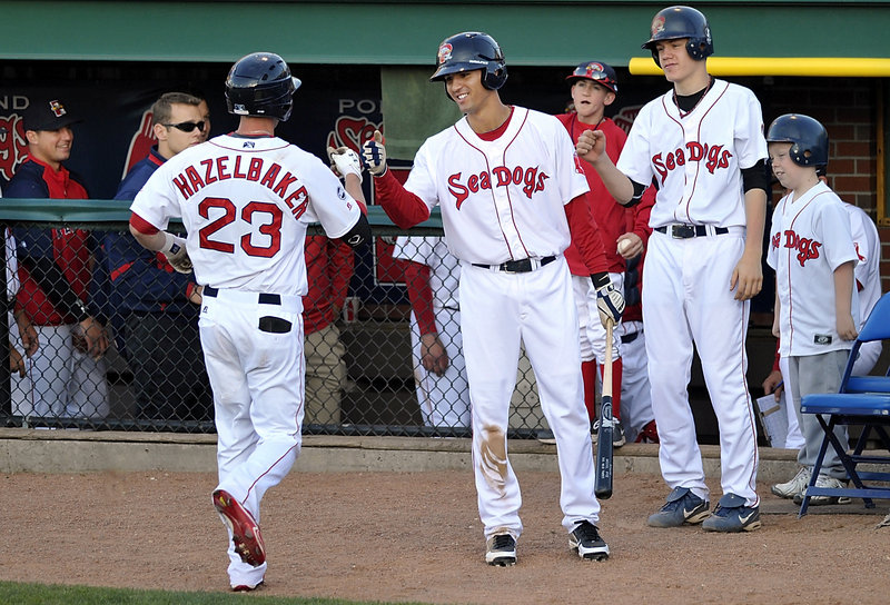 Jeremy Hazelbaker receives congratulations Tuesday night after hitting a home run that gave the Portland Sea Dogs a 1-0 lead before a 6-3 loss to the New Britain Rock Cats at Hadlock Field. Hazelbaker is known for his speed but also has 30 home runs over two seasons plus early this year.