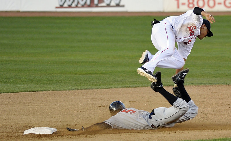 Pedro Florimon of the New Britain Rock Cats is safe at second base as Ryan Dent of the Portland Sea Dogs attempts a tag Tuesday night during New Britain’s 6-3 victory at Hadlock Field. The Sea Dogs have lost three straight as their overall record dropped to 3-10.
