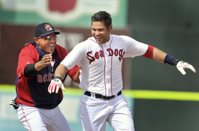 Ronald Bermudez gets chased by teammate Ryan Dent after hitting a winning single off the left-field wall in the bottom of the ninth inning Wednesday at Hadlock Field.