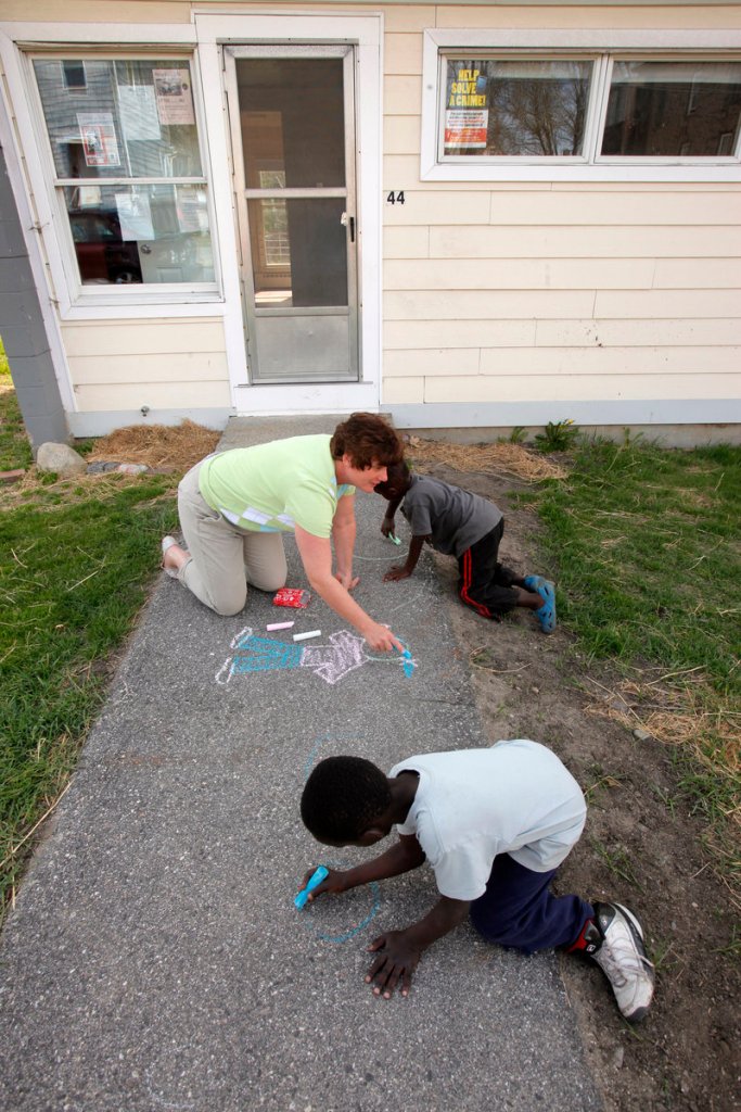 One of the duties of a community services coordinator is getting to know the children and tenants in the neighborhood, as Janine Kaserman was doing Wednesday.