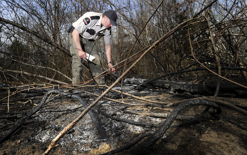 Forest Ranger Matthew Bennett investigates one of two fires that occurred Wednesday afternoon in South Portland’s Hinckley Park. Wednesday was a Class 4 rating day – the second-highest level of fire danger – for the entire state.