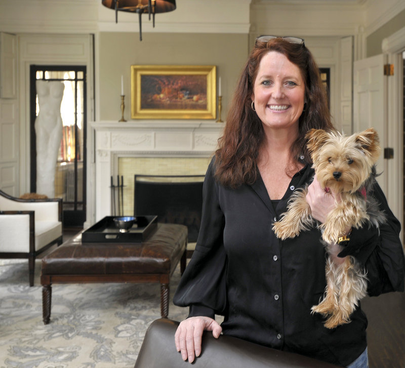 The Danforth Inn owner, Kimberly Swan, with dog Ava, in the “salon,” where guests are served cocktails and hors d’oeuvres before dinner.