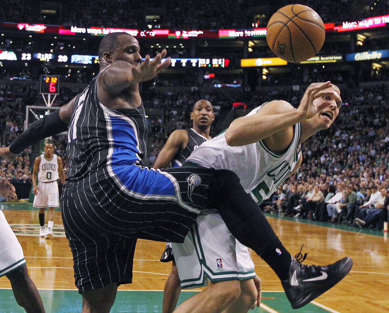 Glen Davis of the Orlando Magic, left, and Greg Stiemsma of the Boston Celtics compete for a rebound Wednesday night during the Celtics’ 102-98 victory at home.