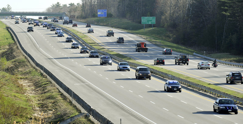 Gathering in Scarborough, law enforcement officers from state and local police departments and other agencies in Maine form a procession on the Maine Turnpike on Thursday to attend the funeral of Greenland Police Chief Michael Maloney in Hampton, N.H.