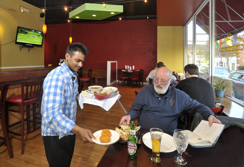 Dancing Elephant owner Iqubol Hossain delivers a meal to Gary Landry of Westbrook.