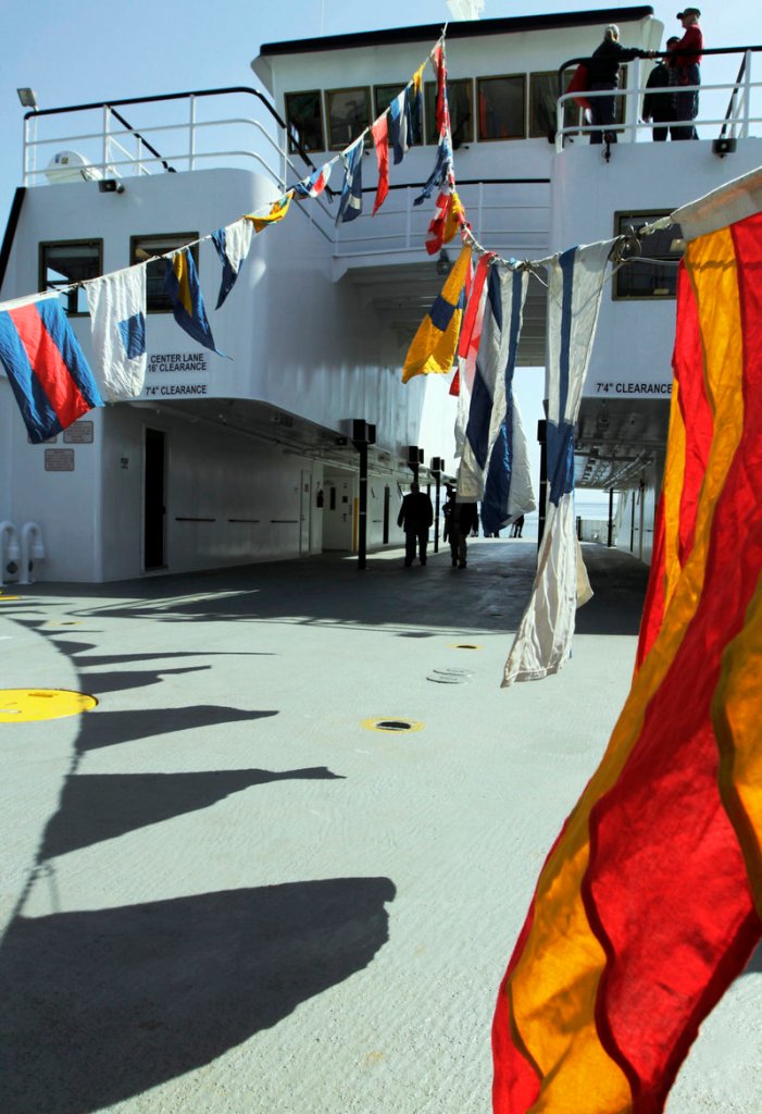 Flags flap in the breeze on the new ferry's deck.