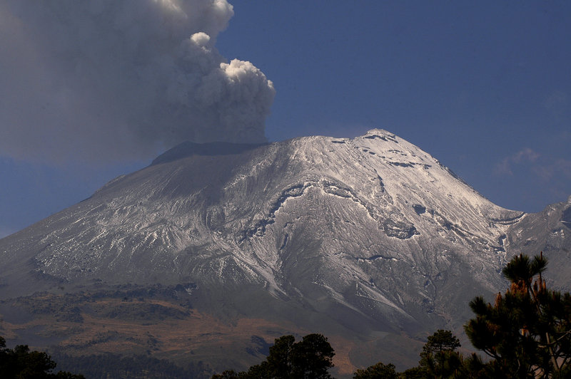 A plume of ash and smoke rises from the Popocatepetl volcano as seen from the town of Santiago Xalizintla in Mexico. The volcano emitted a low-pitched roar early Friday.