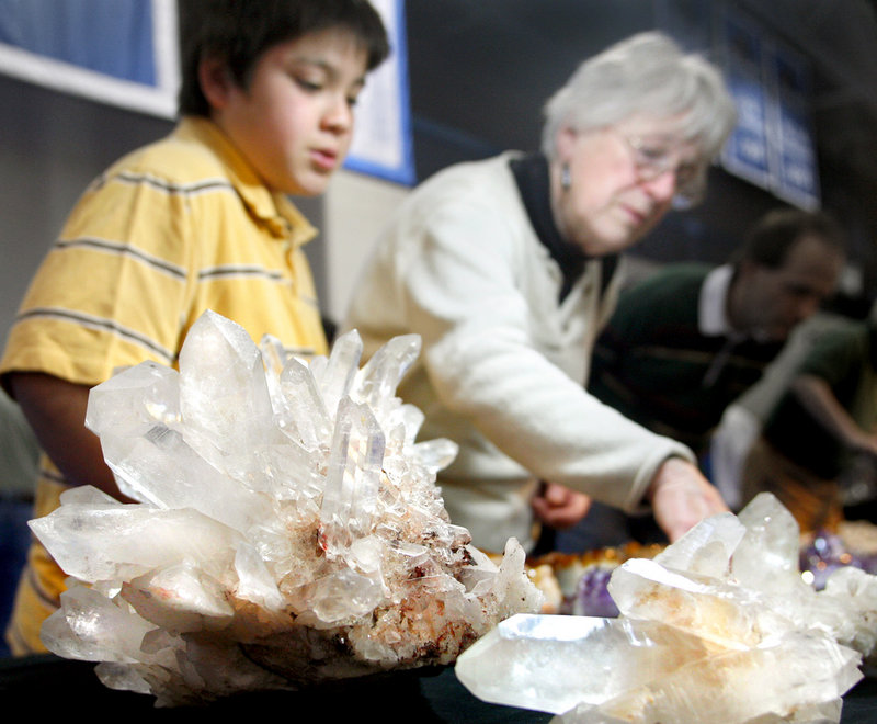 Logan Bantly, 10, of Gorham looks at crystals with his grandmother Laura Bantly of Yarmouth during the 29th annual Maine Mineralogical and Geological Society show at Saint Joseph’s College in Standish on Saturday.