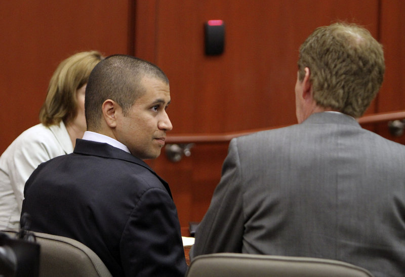 George Zimmerman speaks with his attorney, Mark O’Mara, as he appears in court on Friday in Sanford, Fla.