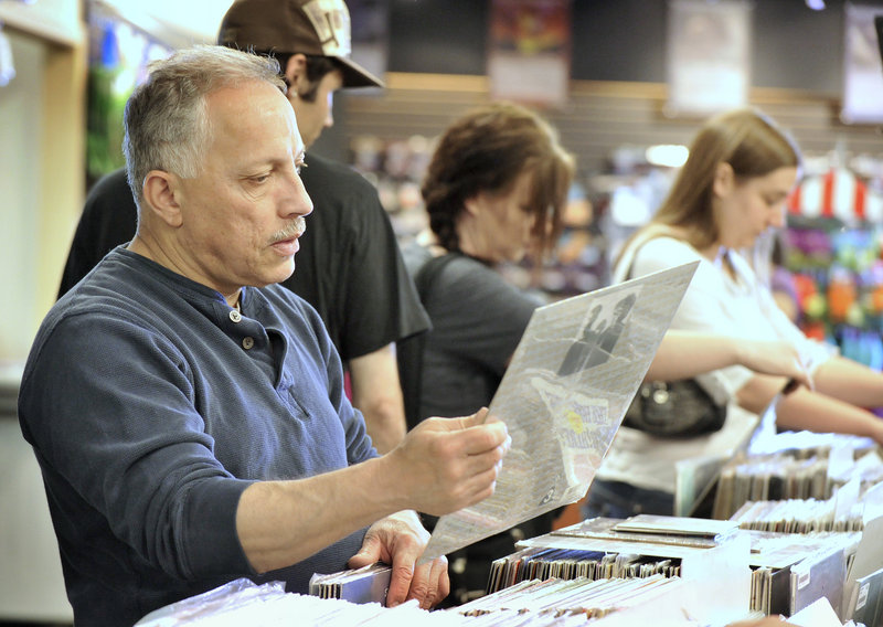 Pete Maestre of Sanford looks through the vinyl selection Saturday at Bull Moose, where he found a 1971 Ugly Custard, The Hollies’ second album and a silver vinyl Metallica release.