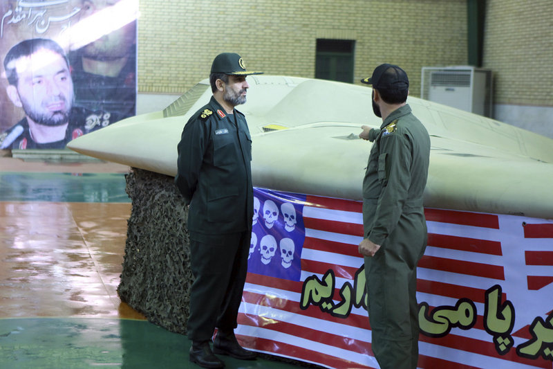 Photo released on Dec. 8, 2011 by Iran’s Revolutionary Guards claims to show Gen. Amir Ali Hajizadeh, left, listening to an unidentified colonel as he points to a U.S. RQ-170 Sentinel drone that Tehran says was downed by its forces. Iran said Sunday that it is building a copy of the drone.