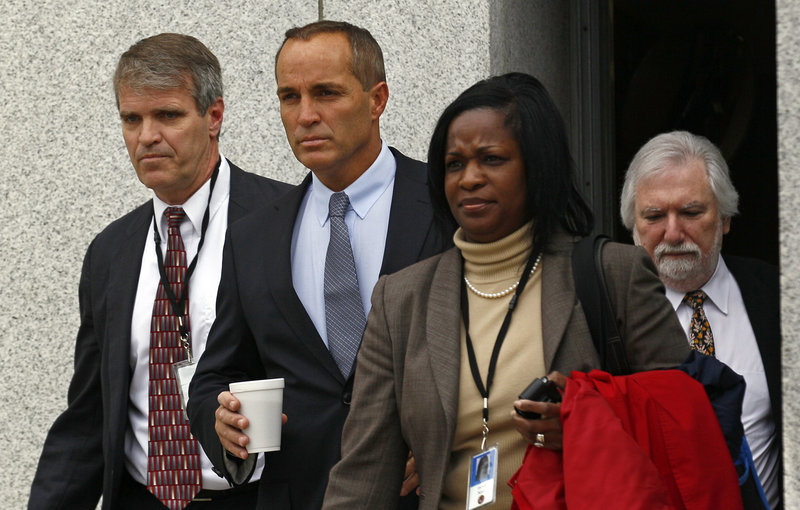 Andrew Young, second from left, former aide to John Edwards, leaves federal court in Greensboro, N.C., on Monday. Young and Edwards were so close that when Edwards got his mistress pregnant in 2007, the married Young publically claimed paternity of his boss' unborn child.