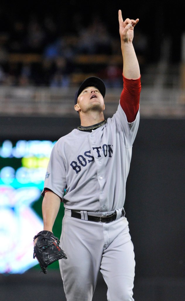 Red Sox pitcher Jon Lester points to a popup off the bat of Justin Morneau in the sixth inning. Lester gave up five runs in seven innings.