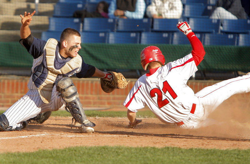 Portland catcher Nick Volger sweeps the tag in time to nab Ben Wessel of Scarborough, who was attempting to score Tuesday during Scarborough’s 5-3 victory at Hadlock Field. Wessel drove in the tie-breaking run with a triple in the seventh inning.