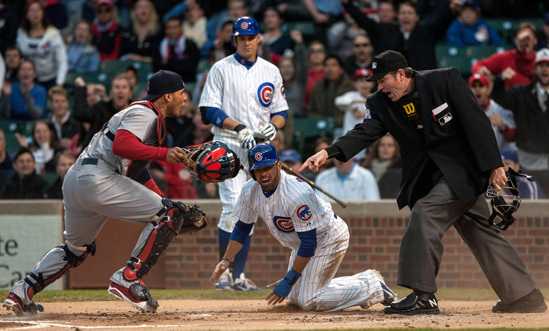 Cards catcher Yadier Molina is not happy after umpire Chris Conroy calls David DeJesus of the Cubs safe Tuesday night.