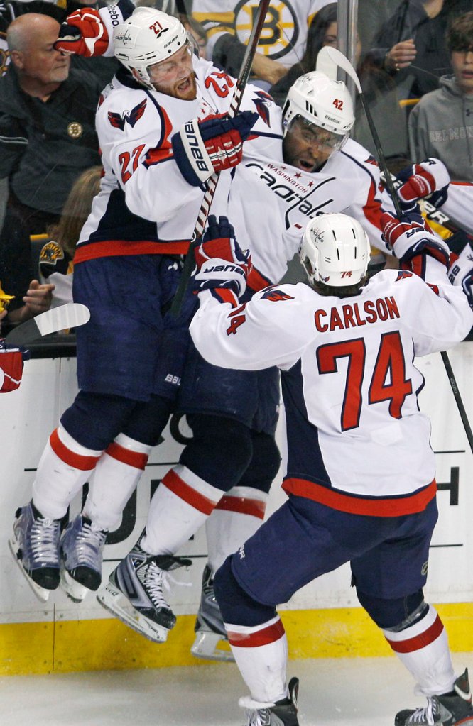 Joel Ward, center, gets mobbed by teammates after scoring the OT goal in Game 7 Wednesday night that gave the Capitals a 2-1 win over the Bruins in Boston.
