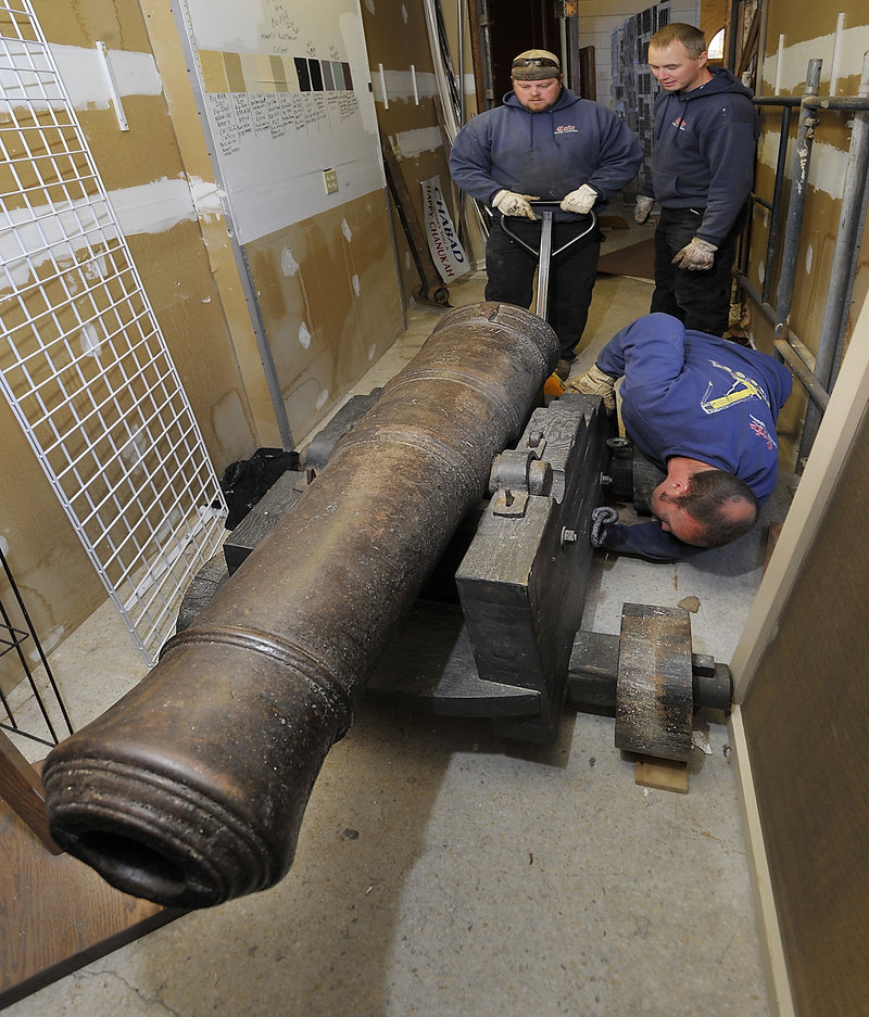 Cote Crane and Rigging moved the 1,200-pound weapon to the Maine Maritime Museum in Bath. Pictured are Derrick Plummer, left, Brian Bosse, back right, and Steve Bosse.