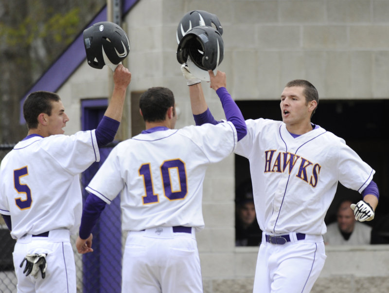 Jack Verrill, right, is congratulated by Luke Fernandes, left, and Matt Brenner after hitting a three-run homer Thursday during a five-run third inning for Marshwood. The Hawks went on to a 6-3 victory against Cheverus, the defending Class A state champion.