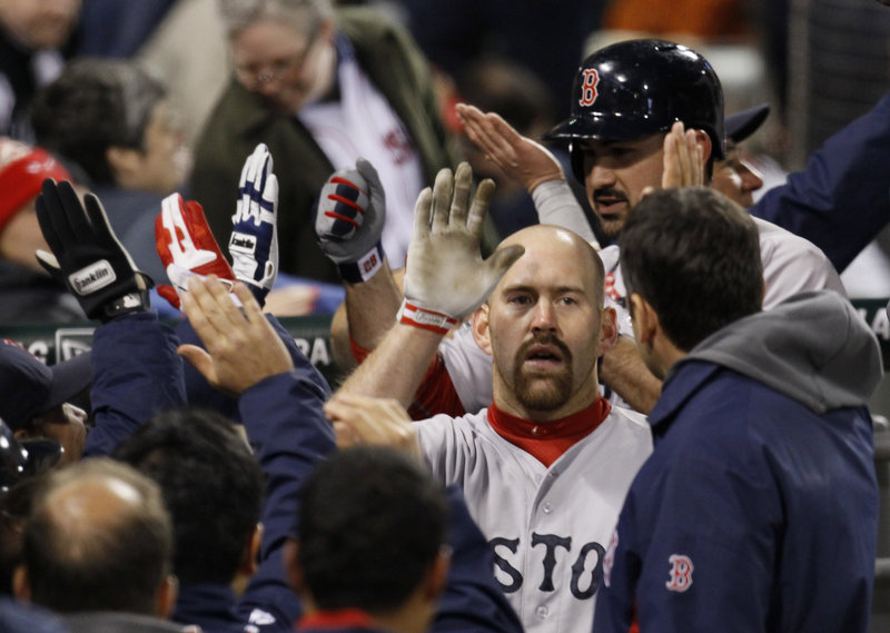 The high-fives are flying around the dugout after a third-inning grand slam by Kevin Youkilis of the Red Sox against the Chicago White Sox on Thursday night.