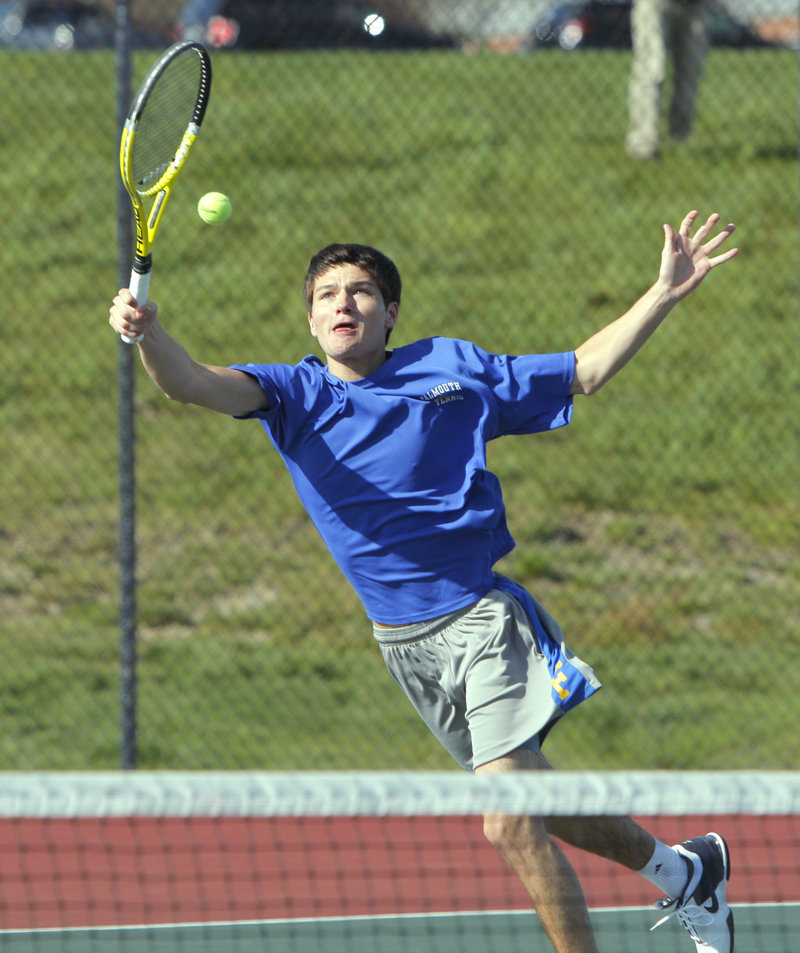 Justin Brogan of Falmouth stretches for a return during his match against Cape Elizabeth’s Matt Gilman. Brogan said the blustery conditions at the Cape Elizabeth High courts were “like playing in a wind tunnel.”