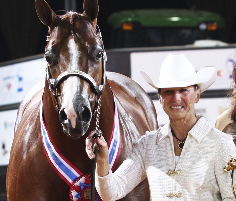 Rita Crundwell of Dixon, Ill., poses with one of her horses at the 2011 American Quarter Horse Association World Championship Show in Oklahoma City. Crundwell, arrested April 17, is accused of siphoning off $30 million from the city of Dixon to support her ranches.